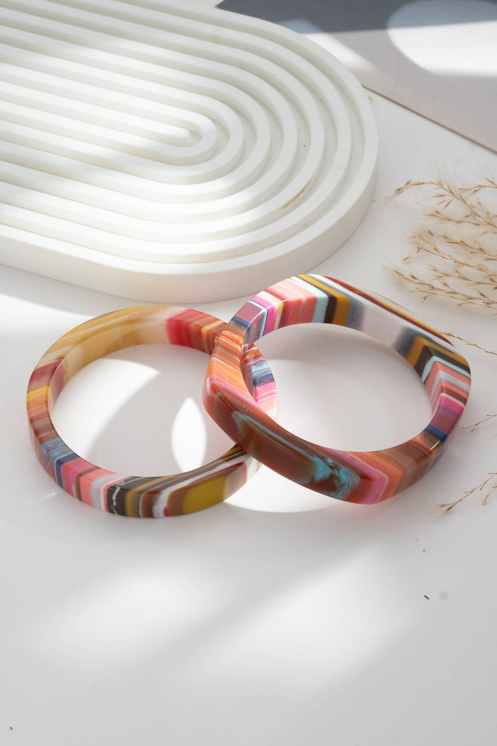 Set of two chic multicolored resin bracelets, round and rectangular